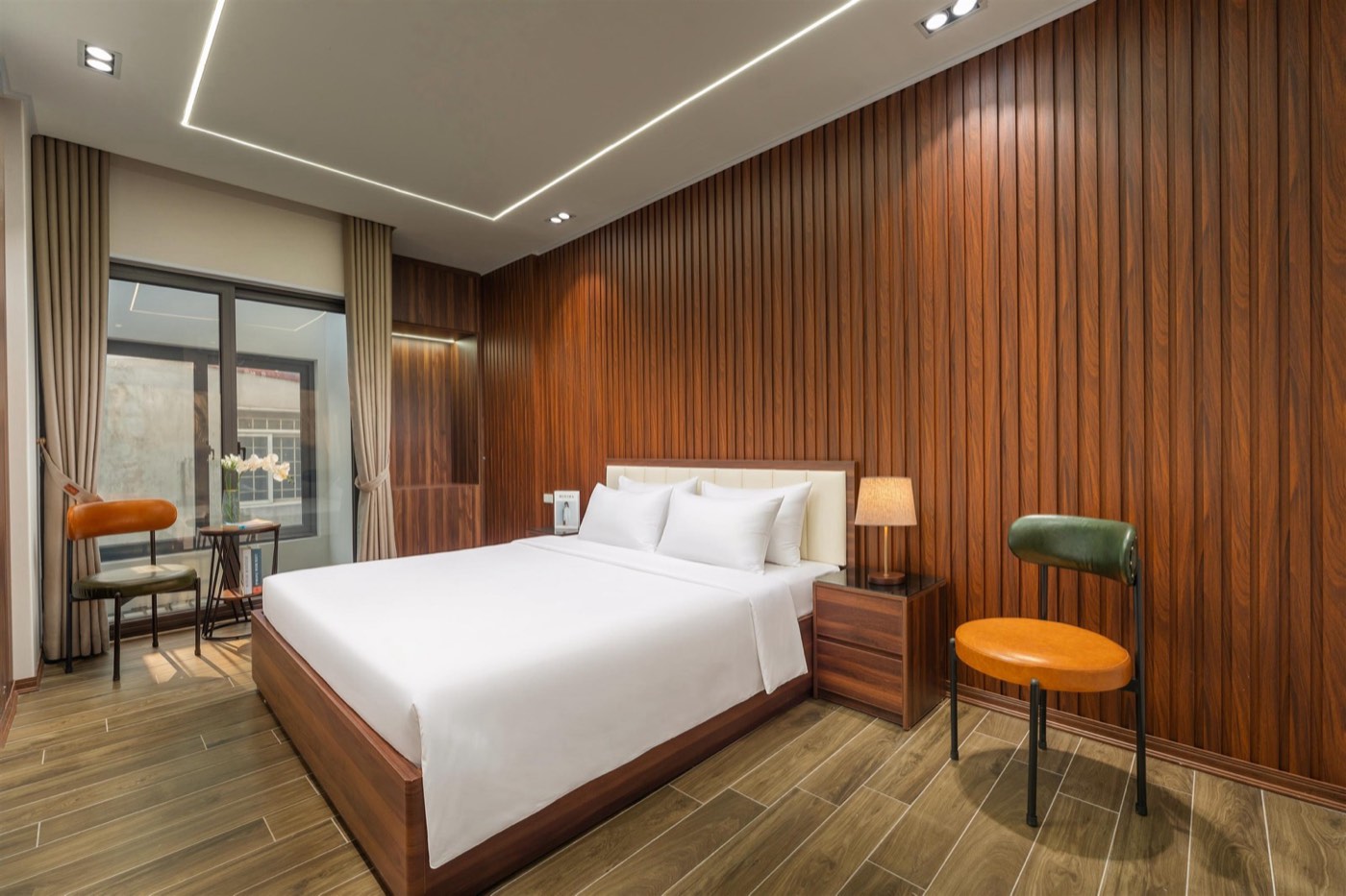 Double room P402 with a large bed and chairs by the window