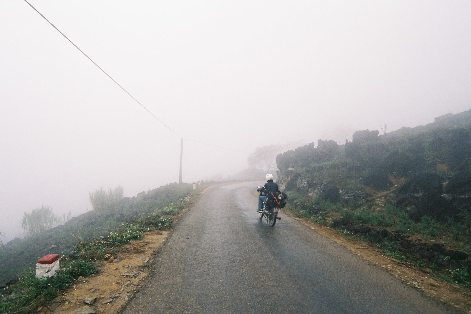 A motorbike on a misty mountain road in Hà Giang