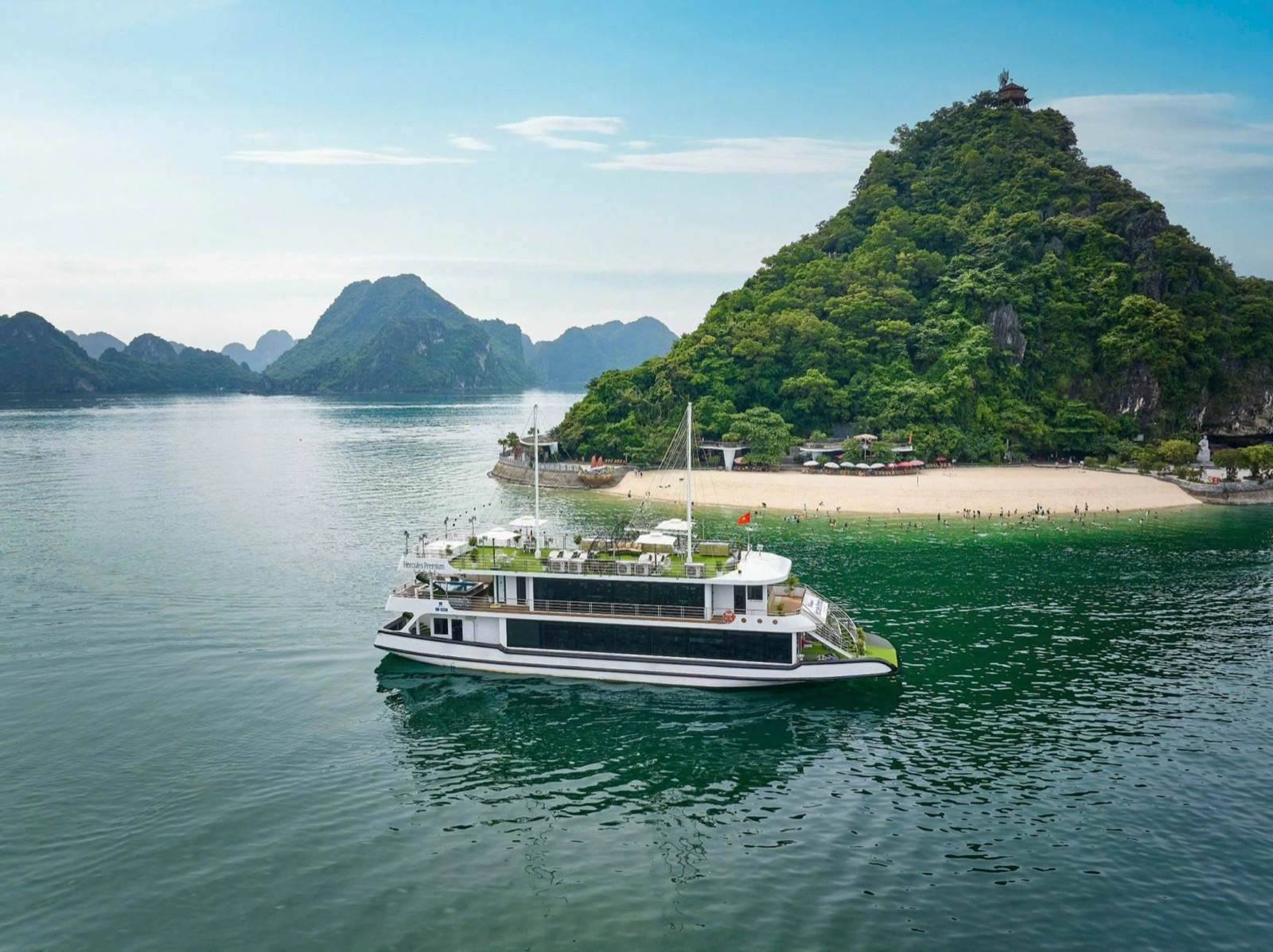 The Hercules day boat cruising past the beach and hilltop pavilion of Ti Tốp island
