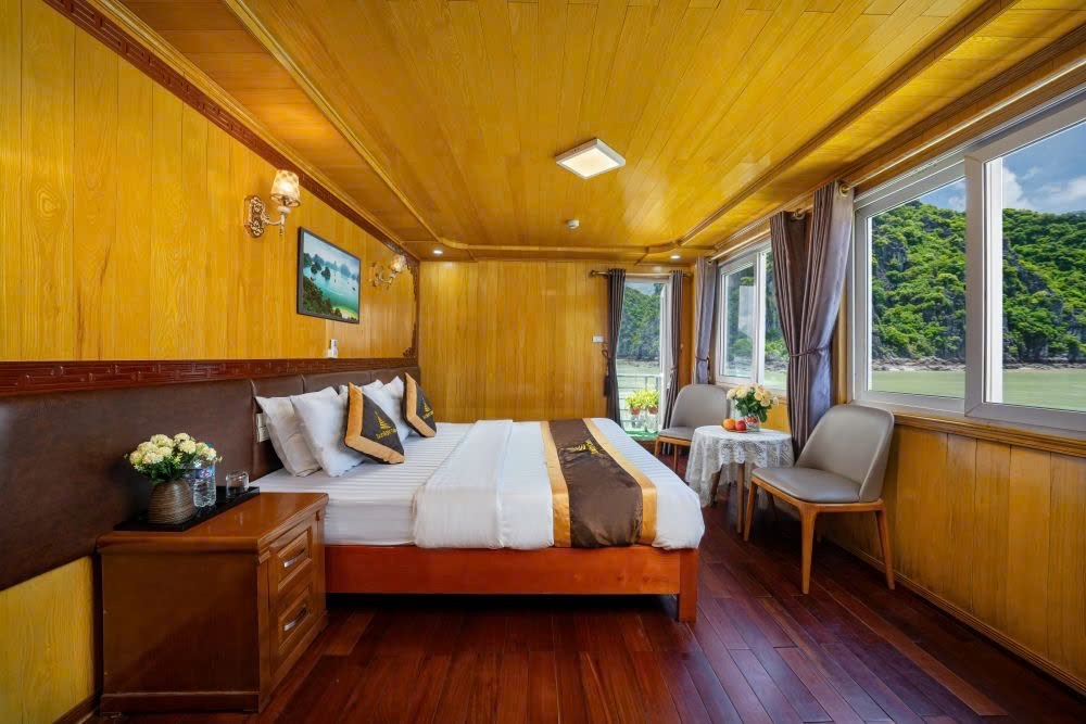 A wood-panelled cabin with a double bed and big windows onto the green islands