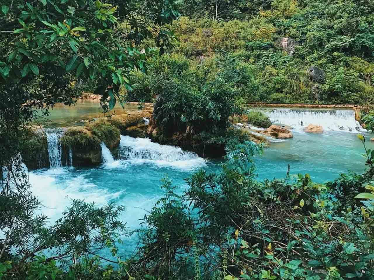 Little cascades and blue pools along a jungle stream near Pác Bó