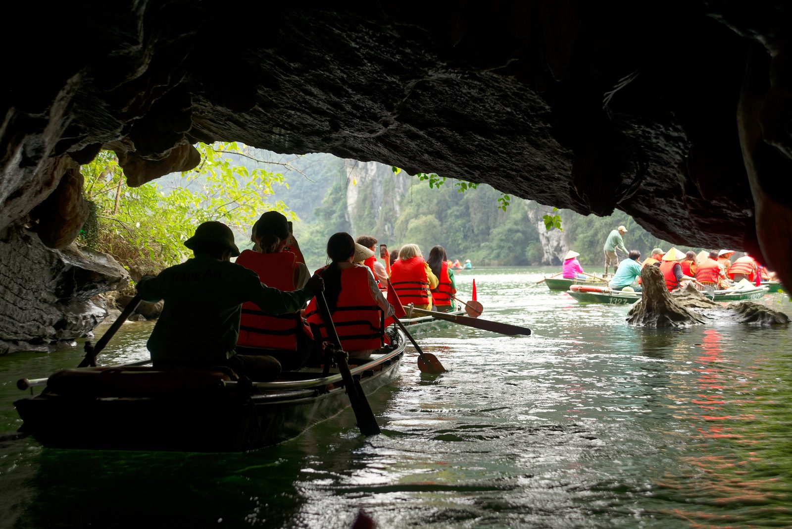 Rowing boats coming out of a cave in Tràng An